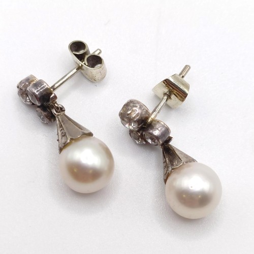 963 - A pair of late 19th/early 20th century pearl and diamond drop earrings