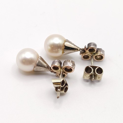 963 - A pair of late 19th/early 20th century pearl and diamond drop earrings