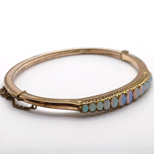 966 - A gold and opal higned bangle