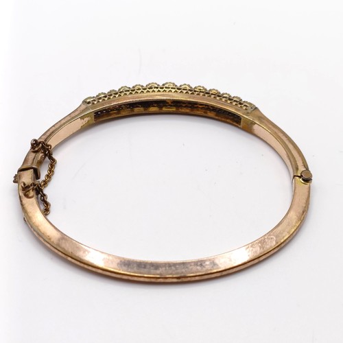 966 - A gold and opal higned bangle