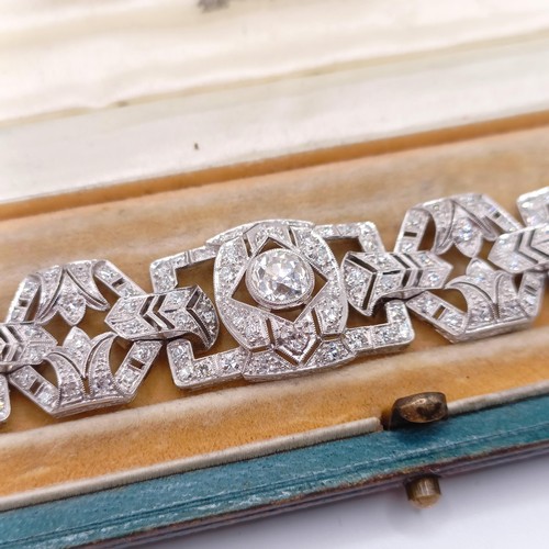 968 - An Art Deco platinum and diamond bracelet, of traditional design, having a pierced setting