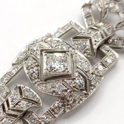 968 - An Art Deco platinum and diamond bracelet, of traditional design, having a pierced setting