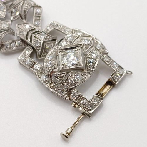 968 - An Art Deco platinum and diamond bracelet, of traditional design, having a pierced setting