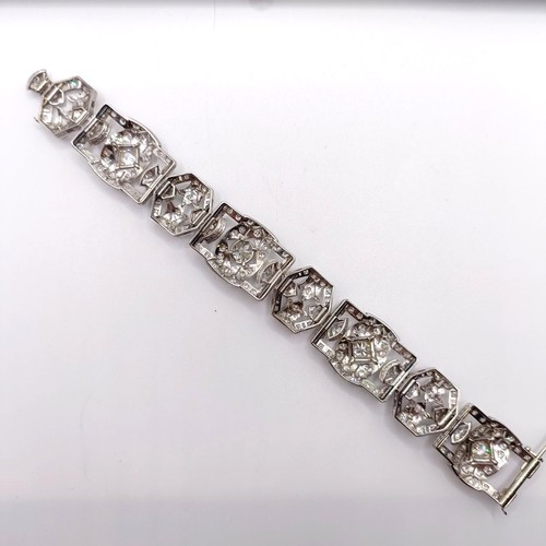 968 - An Art Deco platinum and diamond bracelet, of traditional design, having a pierced setting