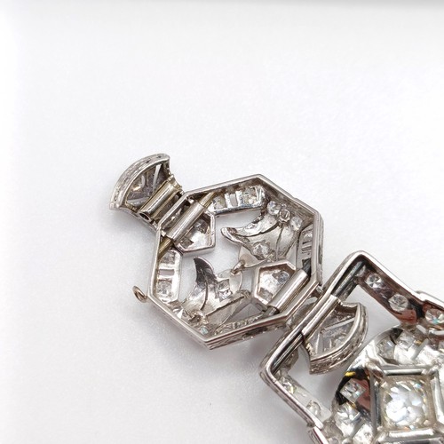 968 - An Art Deco platinum and diamond bracelet, of traditional design, having a pierced setting