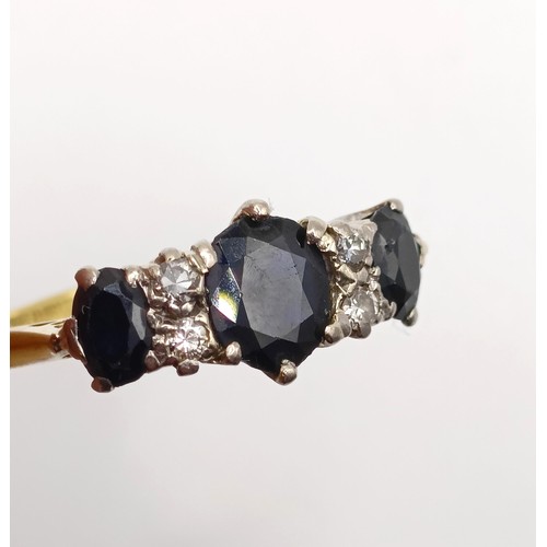 952 - An 18ct gold, sapphire and diamond ring, ring size N