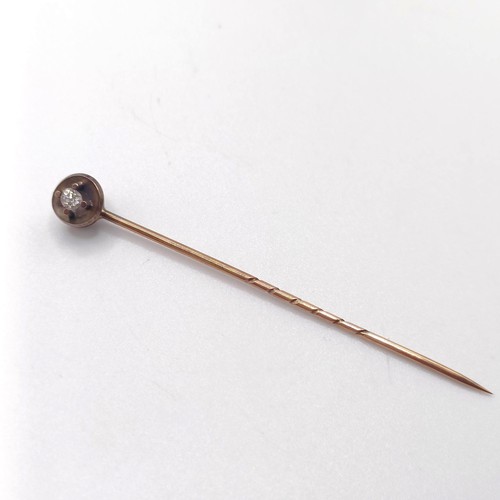 953 - A diamond and yellow metal stick pin, in a vintage jewellery box