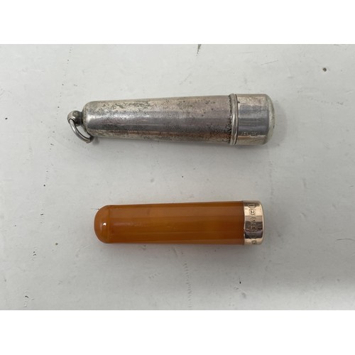 546 - A 9ct gold and amber cheroot, in a silver holder, and a 9ct gold and amber cheroot (2)