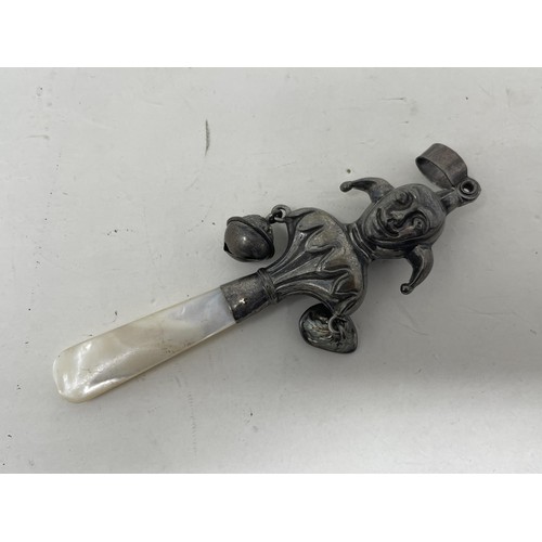 548 - A silver and mother of pearl rattle, in the form of a jester