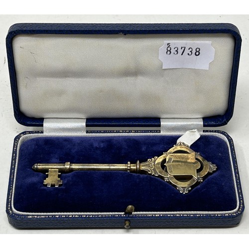 706 - A silver gilt presentation key, Birmingham 1957, cased