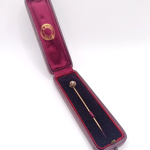 571 - A diamond and yellow metal stick pin, in a vintage jewellery box