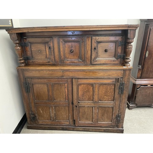 1043 - An oak court cupboard, with panel doors, 143 cm wide and a mirror back, from of a sideboard, 66 x 21... 