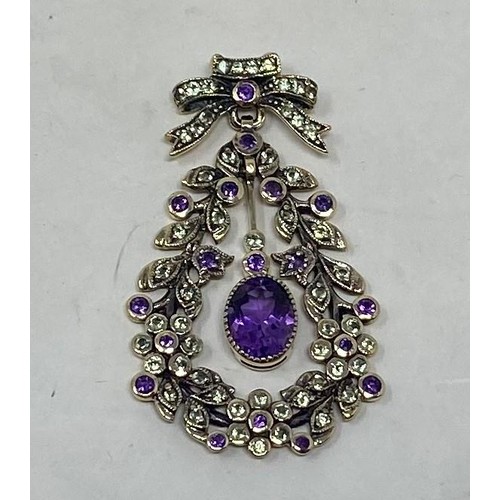 560 - A 9ct gold, amethyst and peridot pendant