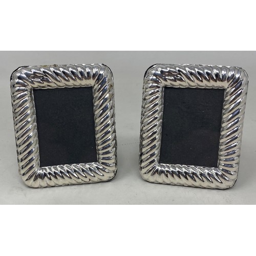 709 - A pair of silver photograph frames, 8 x 7 cm