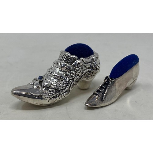 550 - A novelty silver pin cushion, in the form of a shoe, and another (2)