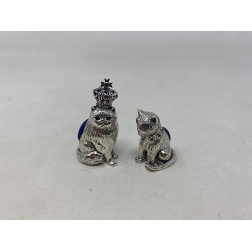 501 - A novelty silver pin cushion, in the form of a cat, and another (2)