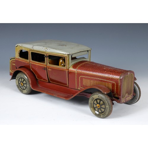 160 - A German TippCo clockwork tinplate limousine, with a chauffeur, in red livery having Dunlop tyres