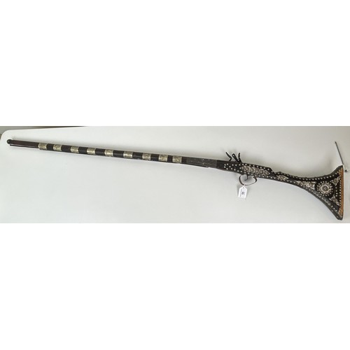 54 - A 19th century Moroccan flintlock gun, 145 cm long