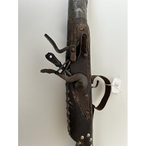 54 - A 19th century Moroccan flintlock gun, 145 cm long