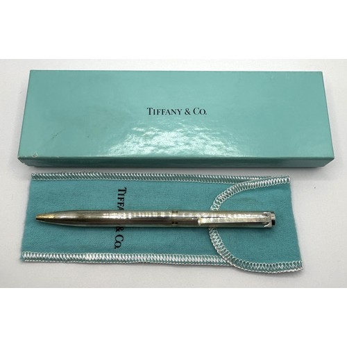 573 - A Tiffany & Co silver ballpoint pen, with a bag, boxed