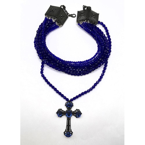 581 - A Jean Paul Gaultier blue bead triple thread necklace, with a cross pendant