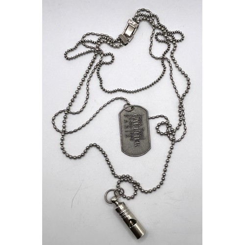 583 - A Jean Paul Gaultier dog tag and whistle, on a silver plated chain