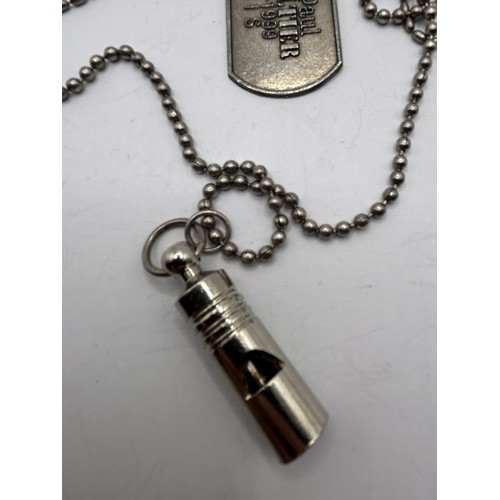 583 - A Jean Paul Gaultier dog tag and whistle, on a silver plated chain