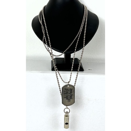 583 - A Jean Paul Gaultier dog tag and whistle, on a silver plated chain