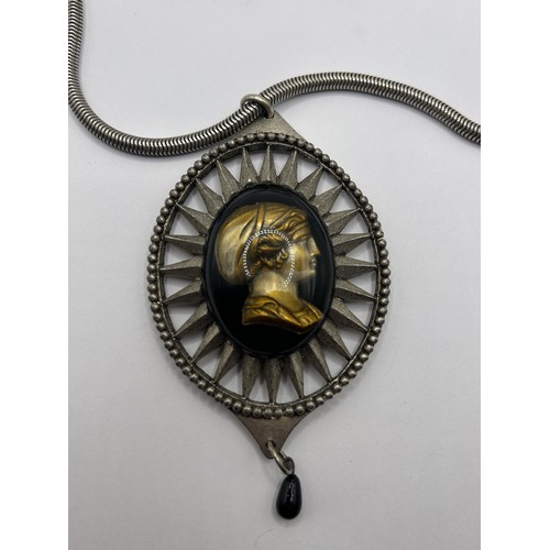 589 - A Jean Paul Gaultier cameo pendant on a chain