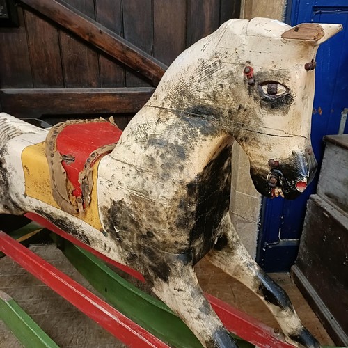 759 - A vintage painted wooden rocking horse, 144 cm wide