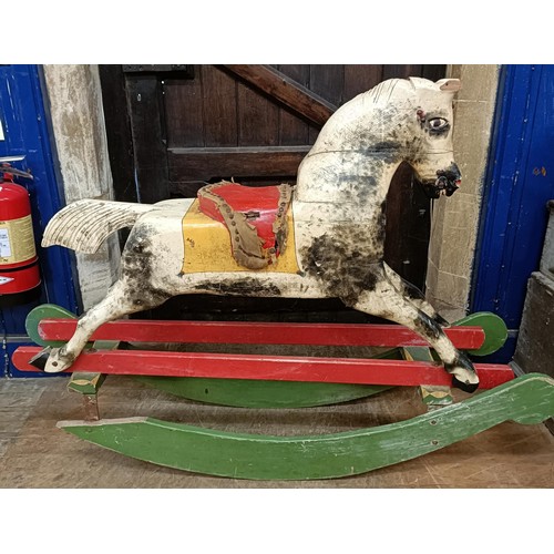 759 - A vintage painted wooden rocking horse, 144 cm wide