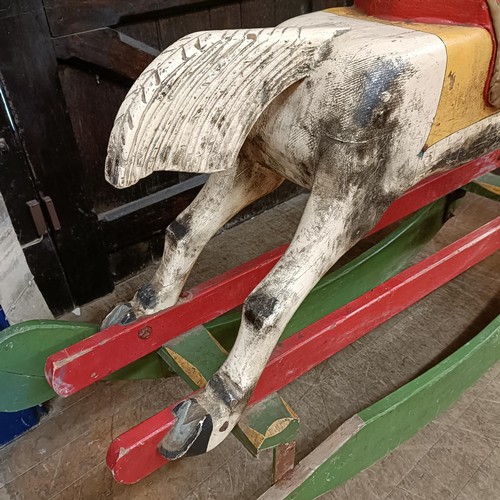 759 - A vintage painted wooden rocking horse, 144 cm wide