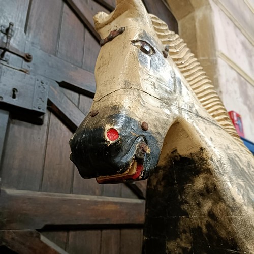 759 - A vintage painted wooden rocking horse, 144 cm wide