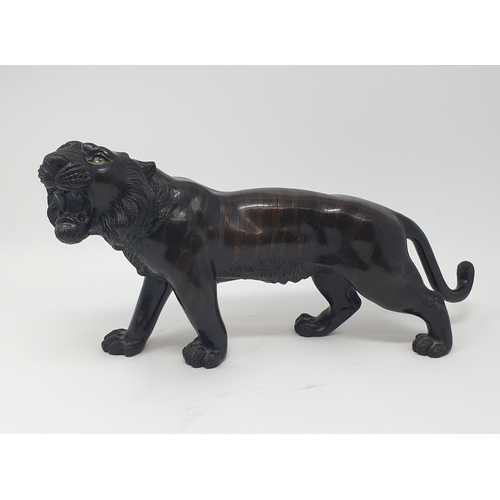 884 - A Japanese bronze tiger, signed, 38 cm