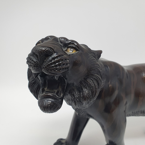 884 - A Japanese bronze tiger, signed, 38 cm