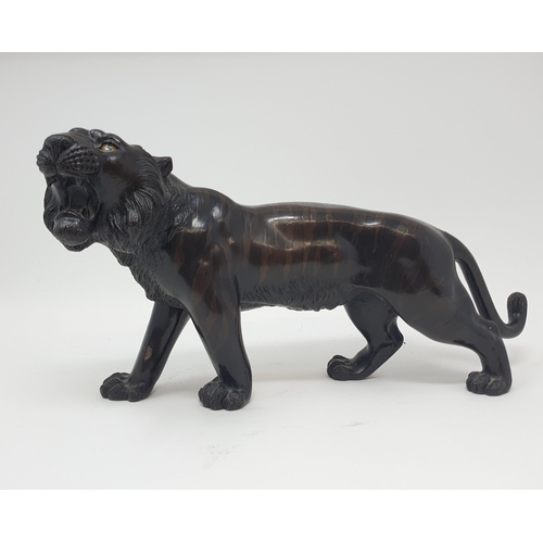 884 - A Japanese bronze tiger, signed, 38 cm