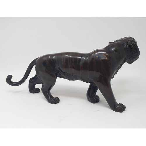 884 - A Japanese bronze tiger, signed, 38 cm