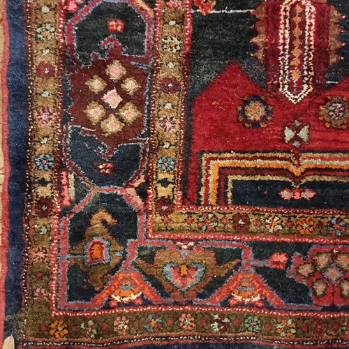 957 - A Turkey style red ground rug, 153 cm wide