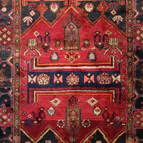 957 - A Turkey style red ground rug, 153 cm wide