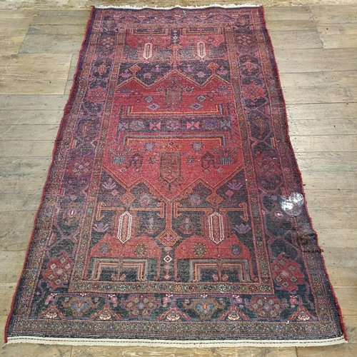 957 - A Turkey style red ground rug, 153 cm wide