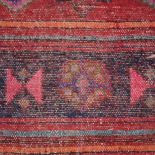 957 - A Turkey style red ground rug, 153 cm wide