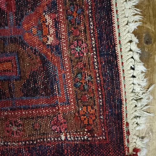 957 - A Turkey style red ground rug, 153 cm wide