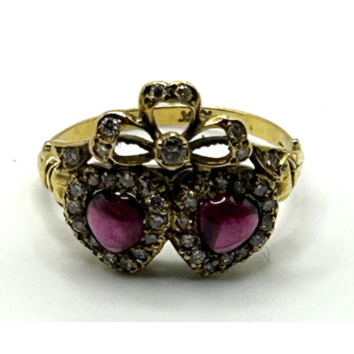 632 - An 18ct gold, diamond and cabochon cut garnet ring