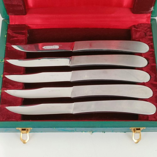 715 - A green tooled leather cutlery box, with five silver plated knives