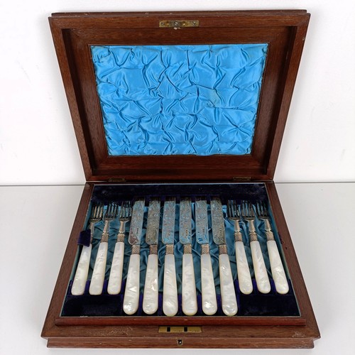 714 - A set of Victorian silver dessert knives and forks, with mother of pearl handles, Sheffield 1880, in... 