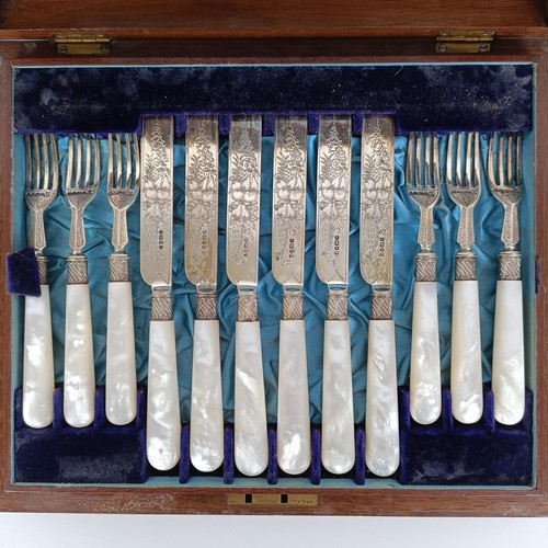 714 - A set of Victorian silver dessert knives and forks, with mother of pearl handles, Sheffield 1880, in... 