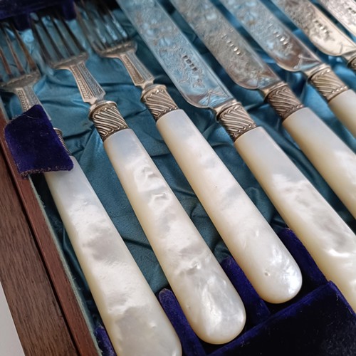 714 - A set of Victorian silver dessert knives and forks, with mother of pearl handles, Sheffield 1880, in... 