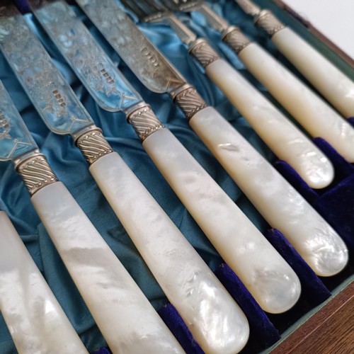 714 - A set of Victorian silver dessert knives and forks, with mother of pearl handles, Sheffield 1880, in... 