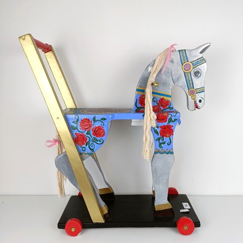 758 - A painted push along horse, 61 cm high