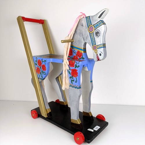 758 - A painted push along horse, 61 cm high